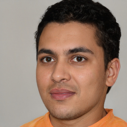 Joyful white young-adult male with short  black hair and brown eyes