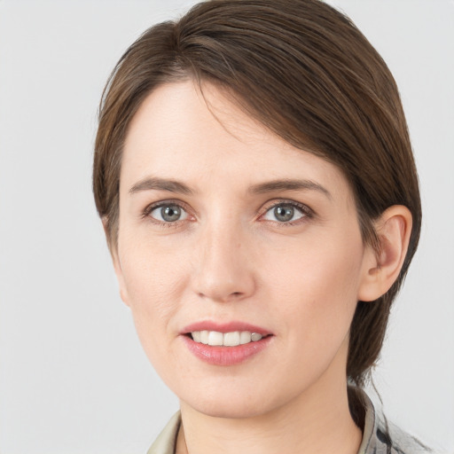 Joyful white young-adult female with medium  brown hair and grey eyes