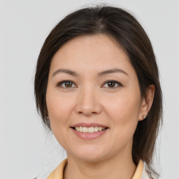 Joyful white adult female with medium  brown hair and brown eyes