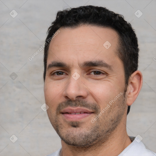 Joyful white adult male with short  black hair and brown eyes