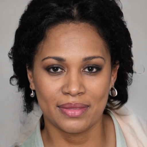 Joyful latino adult female with medium  brown hair and brown eyes