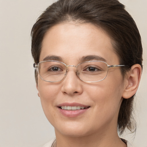 Joyful white adult female with medium  brown hair and brown eyes