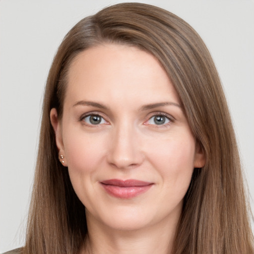 Joyful white young-adult female with long  brown hair and grey eyes