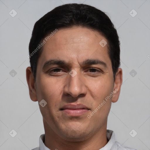 Joyful white adult male with short  black hair and brown eyes