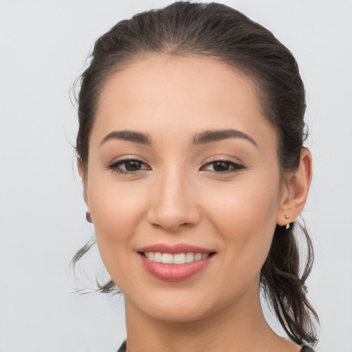 Joyful white young-adult female with long  brown hair and brown eyes