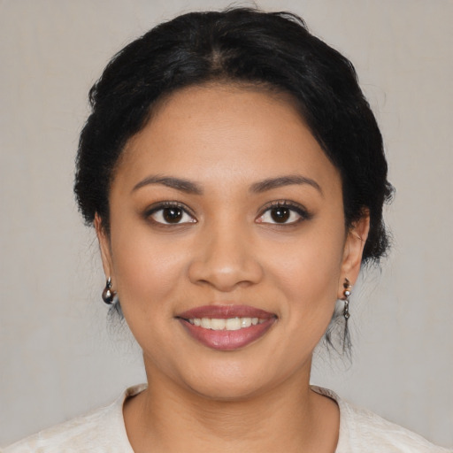 Joyful latino young-adult female with medium  black hair and brown eyes