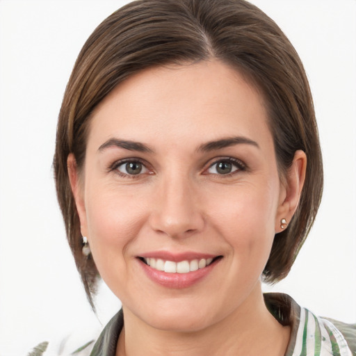 Joyful white young-adult female with medium  brown hair and grey eyes