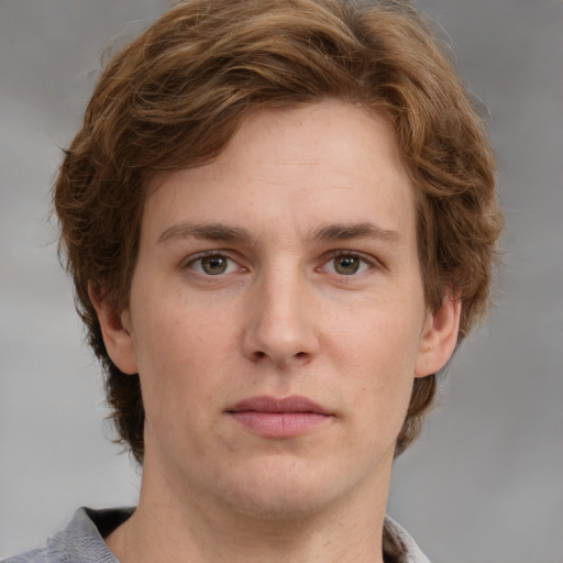 Joyful white young-adult male with medium  brown hair and grey eyes