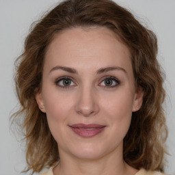 Joyful white young-adult female with medium  brown hair and green eyes