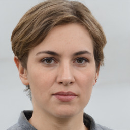 Joyful white adult female with short  brown hair and grey eyes