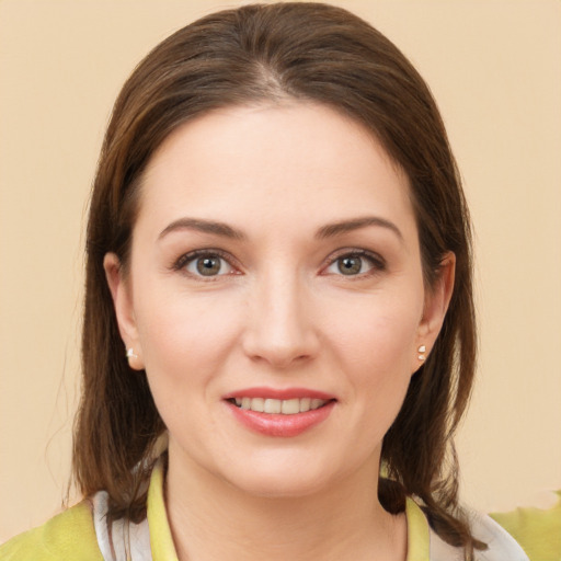 Joyful white young-adult female with medium  brown hair and brown eyes