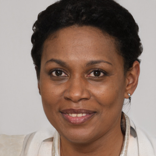 Joyful black adult female with short  brown hair and brown eyes