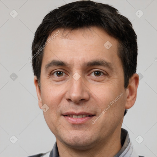 Joyful white adult male with short  brown hair and brown eyes