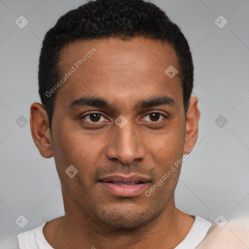 Joyful black young-adult male with short  brown hair and brown eyes