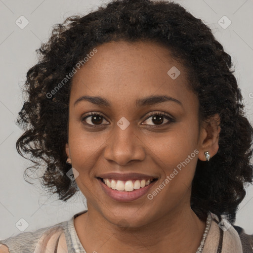 Joyful black young-adult female with long  brown hair and brown eyes