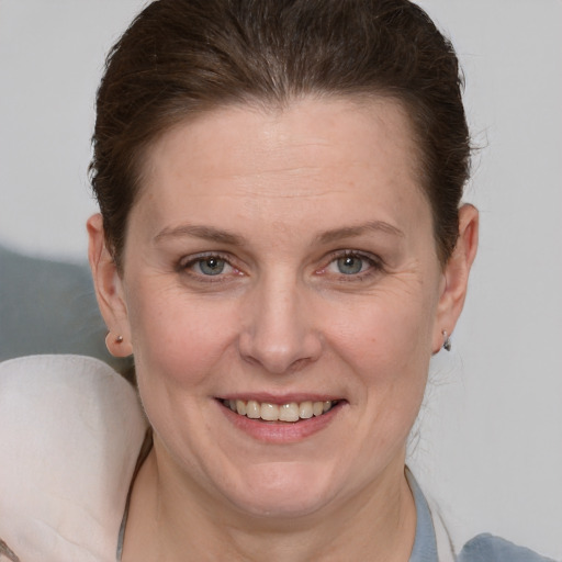 Joyful white adult female with medium  brown hair and grey eyes