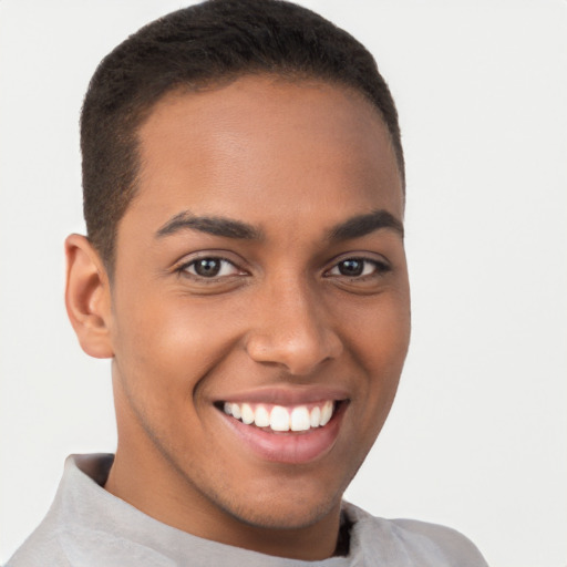 Joyful latino young-adult male with short  brown hair and brown eyes