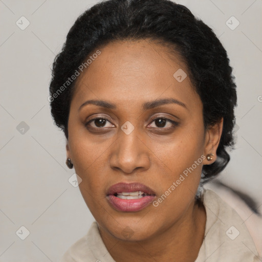 Joyful black adult female with short  black hair and brown eyes