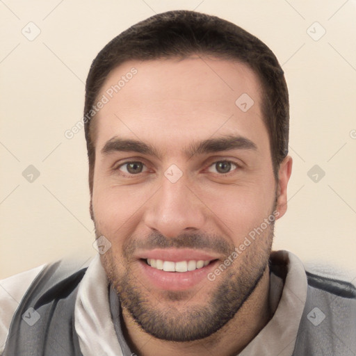 Joyful white young-adult male with short  brown hair and brown eyes