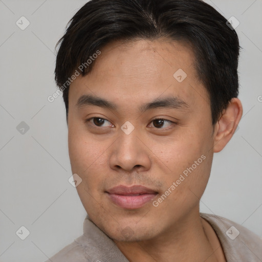 Joyful asian young-adult male with short  brown hair and brown eyes