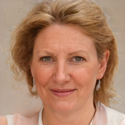 Joyful white adult female with medium  brown hair and blue eyes