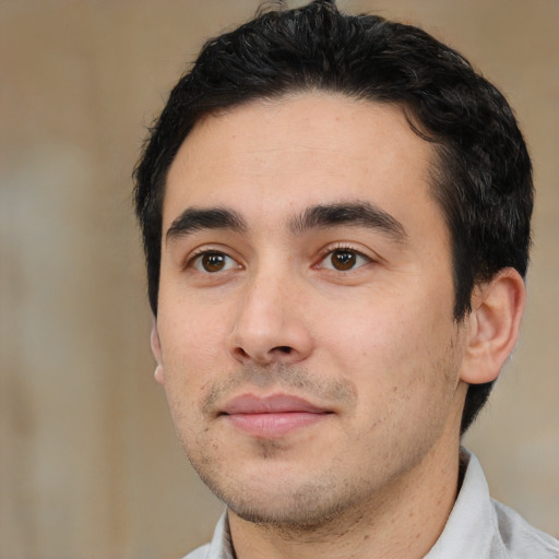 Joyful white young-adult male with short  black hair and brown eyes