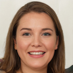 Joyful white young-adult female with long  brown hair and blue eyes