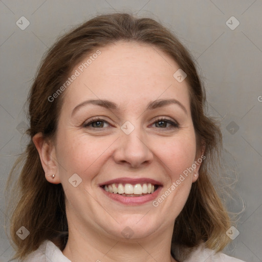 Joyful white adult female with medium  brown hair and grey eyes