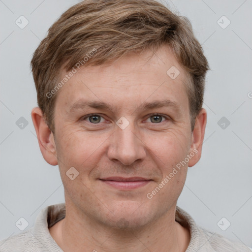 Joyful white adult male with short  brown hair and grey eyes