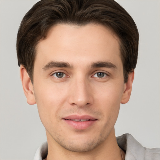 Joyful white young-adult male with short  brown hair and brown eyes