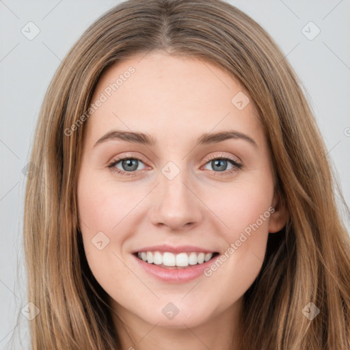 Joyful white young-adult female with long  brown hair and green eyes