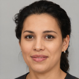 Joyful latino young-adult female with medium  brown hair and brown eyes