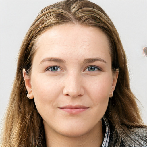 Joyful white young-adult female with long  brown hair and blue eyes