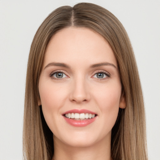 Joyful white young-adult female with long  brown hair and green eyes