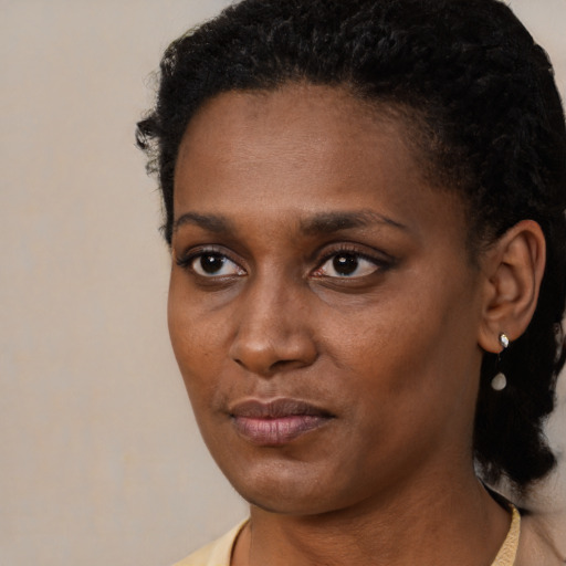 Neutral black young-adult female with short  black hair and brown eyes