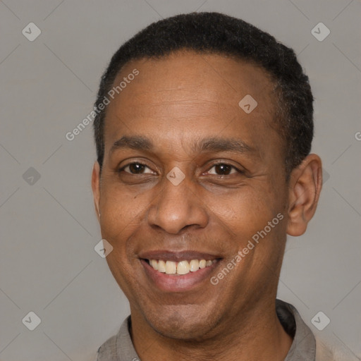 Joyful latino adult male with short  brown hair and brown eyes