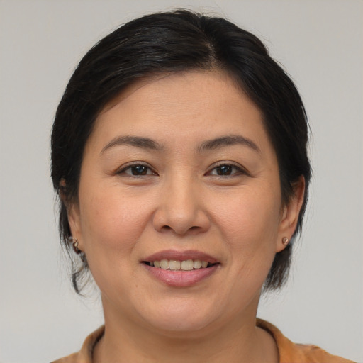 Joyful asian young-adult female with medium  brown hair and brown eyes