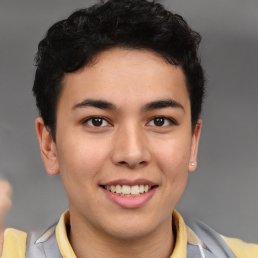 Joyful latino young-adult male with short  brown hair and brown eyes