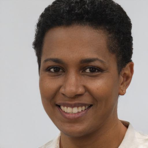 Joyful black young-adult female with short  brown hair and brown eyes
