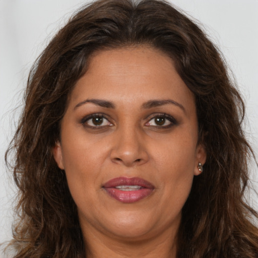 Joyful white adult female with long  brown hair and brown eyes
