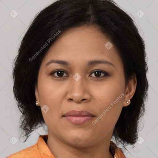 Joyful latino young-adult female with medium  brown hair and brown eyes