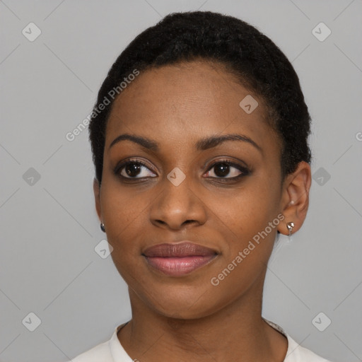 Joyful black young-adult female with short  black hair and brown eyes