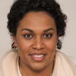 Joyful black adult female with short  brown hair and brown eyes