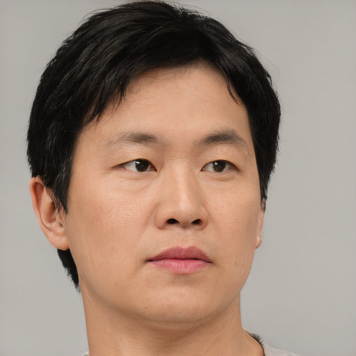 Neutral asian adult male with short  brown hair and brown eyes
