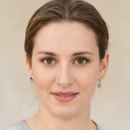 Joyful white young-adult female with medium  brown hair and green eyes