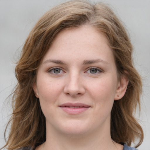 Joyful white young-adult female with medium  brown hair and blue eyes