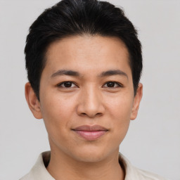 Joyful asian young-adult male with short  brown hair and brown eyes