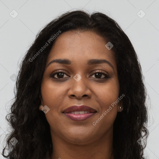 Joyful black young-adult female with long  brown hair and brown eyes