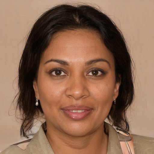 Joyful black adult female with medium  brown hair and brown eyes