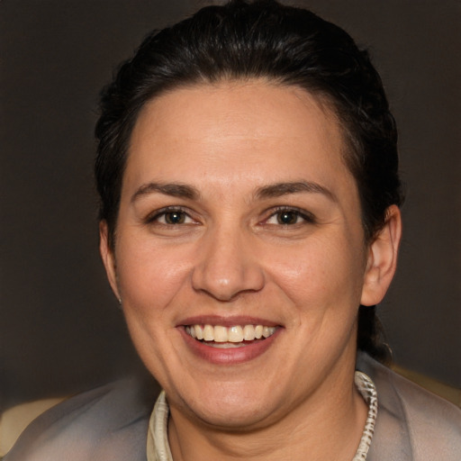 Joyful white adult female with short  brown hair and brown eyes